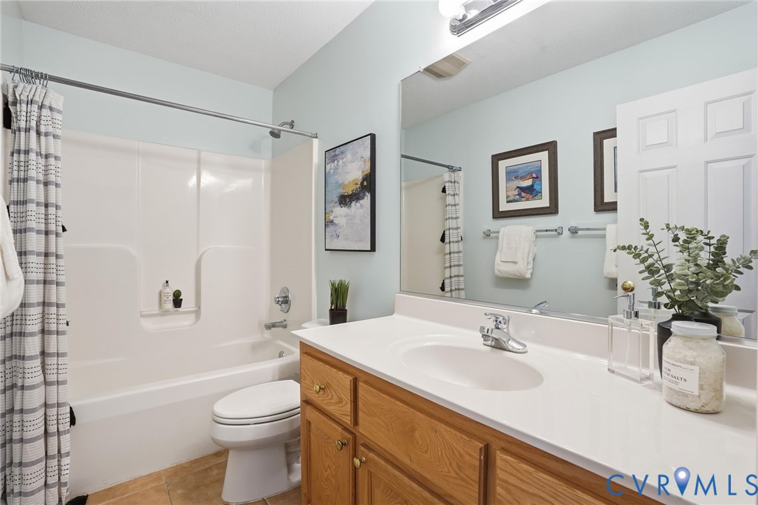 8420 Lee Davis Road Mechanicsville, VA 23116 - Photo 32 of 42 a bathroom with a sink a toilet and shower