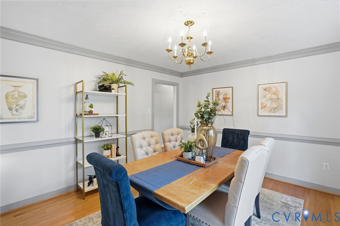 8420 Lee Davis Road Mechanicsville, VA 23116 - Photo 5 of 42 a view of a dining room with furniture wooden floor and a chandelier