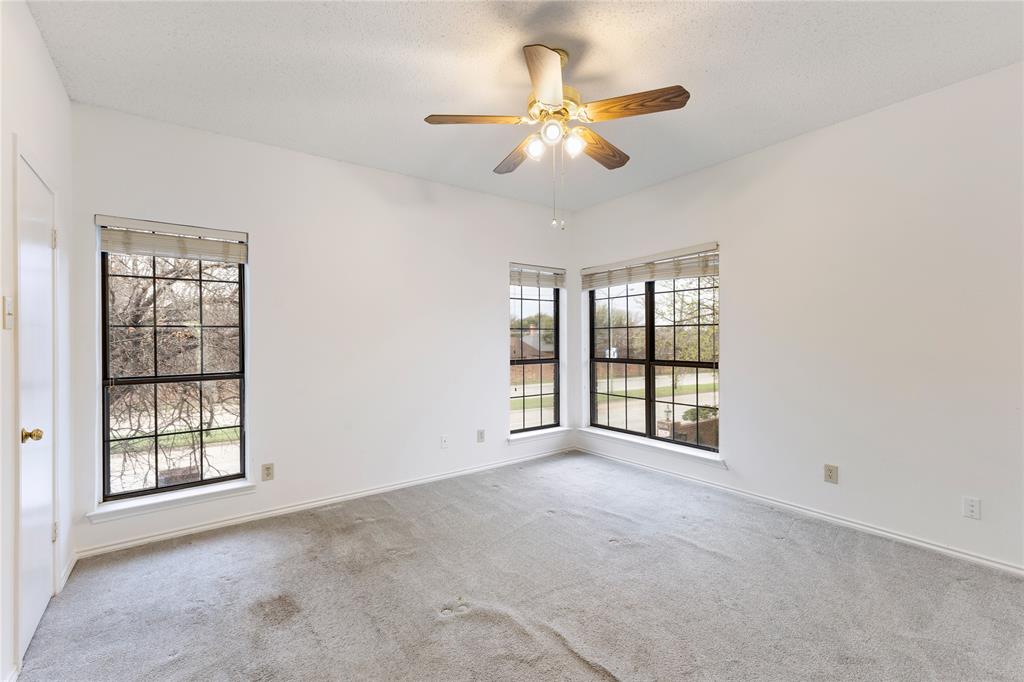 5859 Frankford Road, Unit 812 Dallas, TX 75252 - Photo 18 of 29 an empty room with chandelier fan and windows