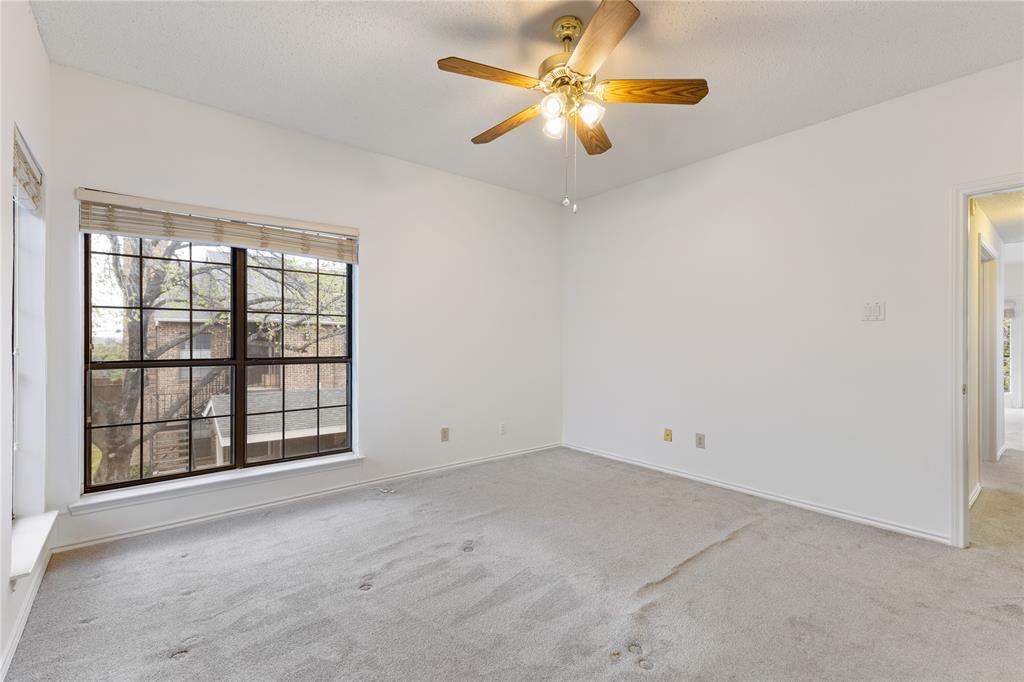 5859 Frankford Road, Unit 812 Dallas, TX 75252 - Photo 19 of 29 an empty room with chandelier fan and windows