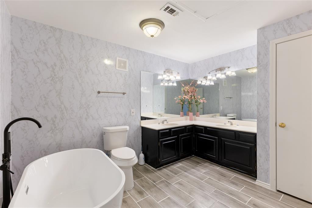 5859 Frankford Road, Unit 812 Dallas, TX 75252 - Photo 21 of 29 a spacious bathroom with a bathtub sink mirror vanity and toilet