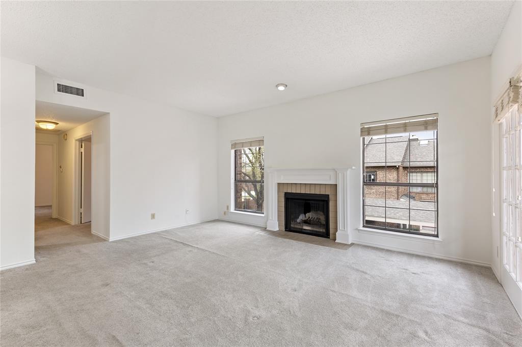 5859 Frankford Road, Unit 812 Dallas, TX 75252 - Photo 5 of 29 an empty room with fireplace and windows
