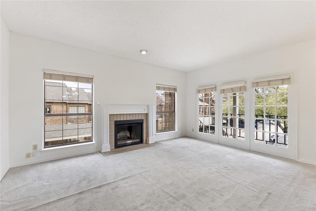 5859 Frankford Road, Unit 812 Dallas, TX 75252 - Photo 6 of 29 an empty room with furniture and a fireplace