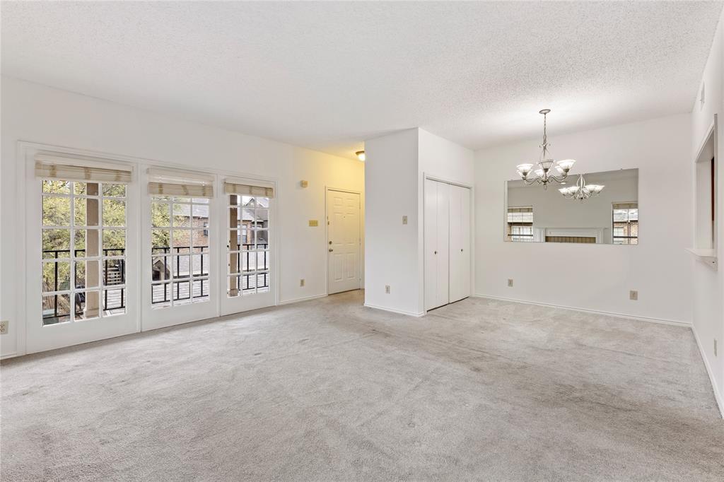 5859 Frankford Road, Unit 812 Dallas, TX 75252 - Photo 8 of 29 an empty room with chandelier fan and windows