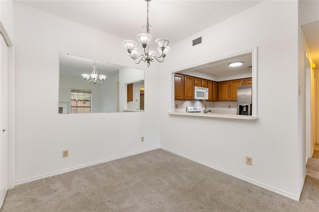 5859 Frankford Road, Unit 812 Dallas, TX 75252 - Photo 10 of 29 a view of a hallway with a chandelier fan and wooden floor