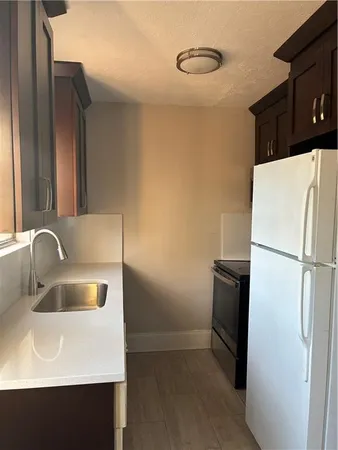 a close view of a sink a refrigerator and washer