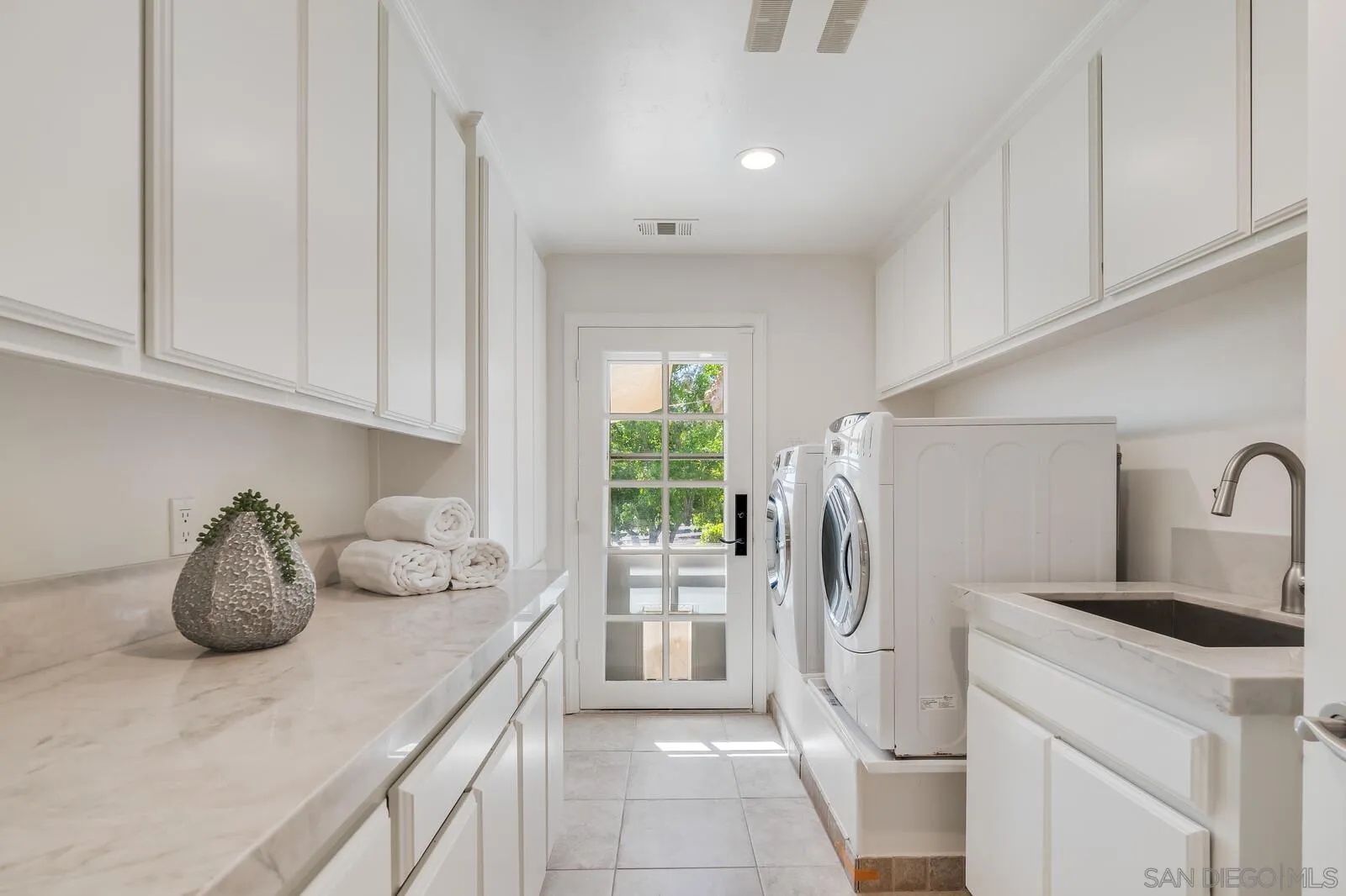 3620 Dove Hollow Road Encinitas, CA 92024 - Photo 49 of 75 a kitchen with stainless steel appliances white cabinets and a window