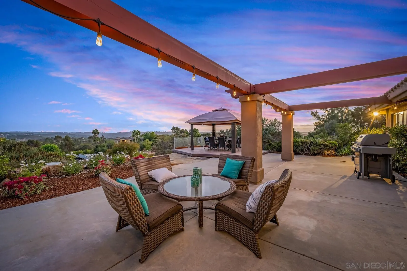 3620 Dove Hollow Road Encinitas, CA 92024 - Photo 59 of 75 a view of a patio with a table chairs and a backyard