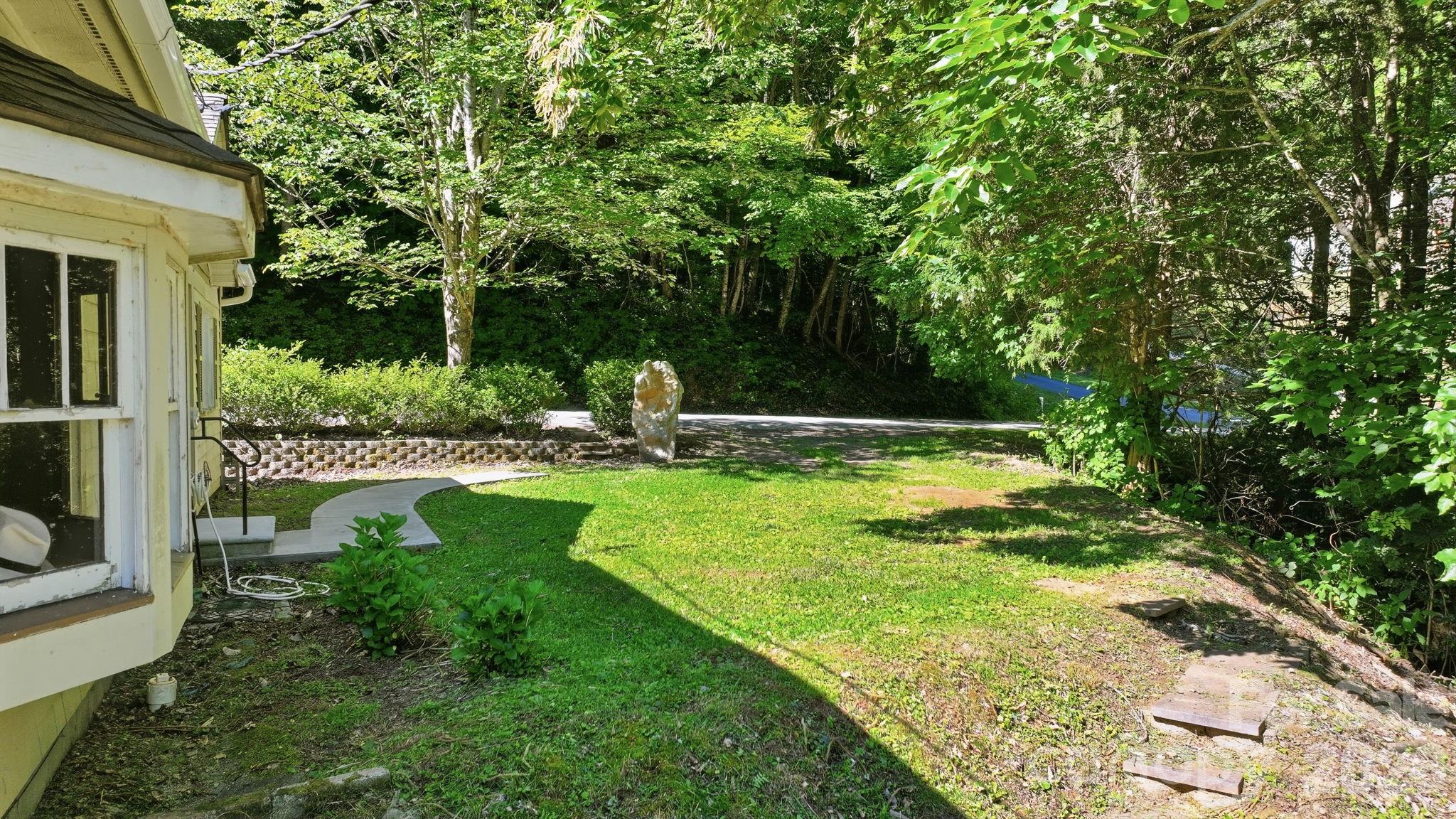 583 Dark Ridge Road Sylva, NC 28779 - Photo 8 of 48 a view of a garden with a tree