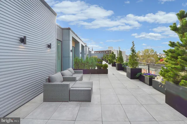 a view of a terrace with couches and potted plants