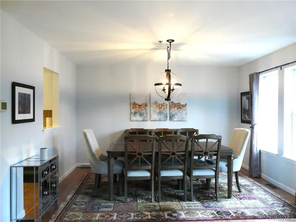 a living room with furniture a fireplace and a floor to ceiling window