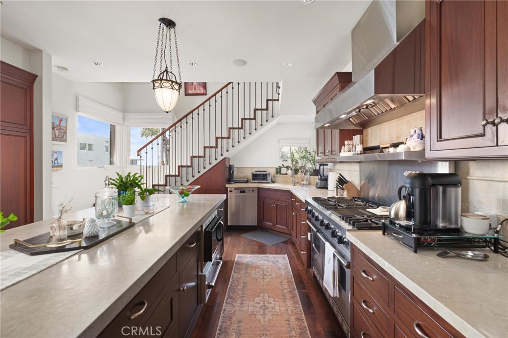 401 27th Street Manhattan Beach, CA 90266 - Photo 10 of 36 a kitchen with kitchen island granite countertop lots of counter top space a sink and stainless steel appliances