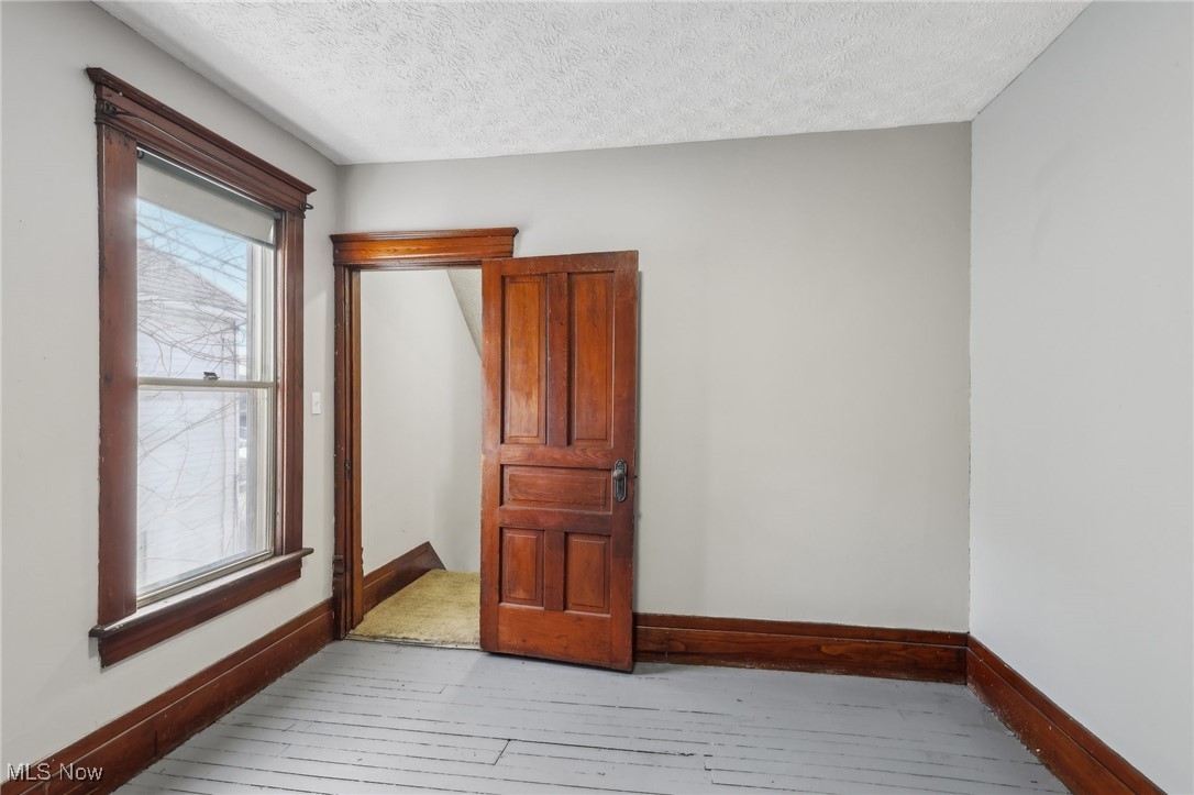 73 East York Street Akron, OH 44310 - Photo 22 of 36 Spare room with light hardwood / wood-style flooring and a textured ceiling