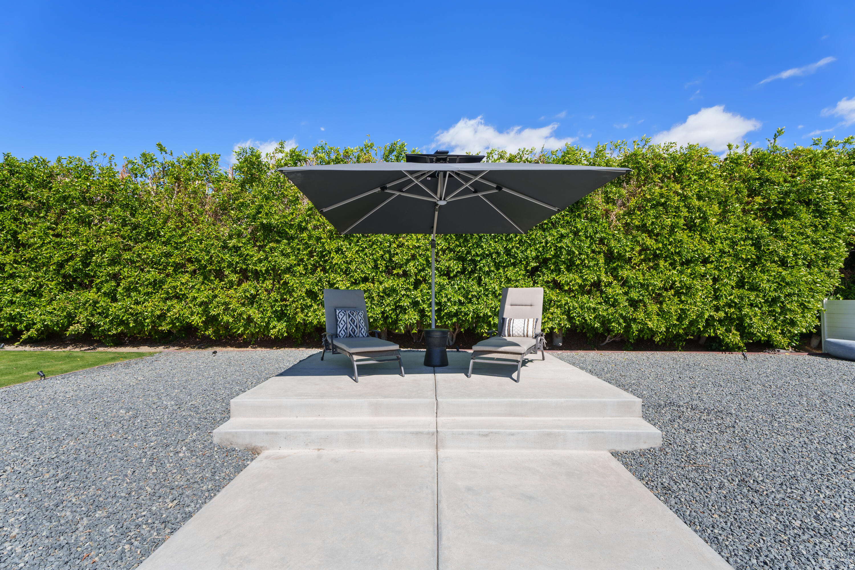 37081 Palmdale Road Rancho Mirage, CA 92270 - Photo 37 of 46 a backyard of a house with table and chairs