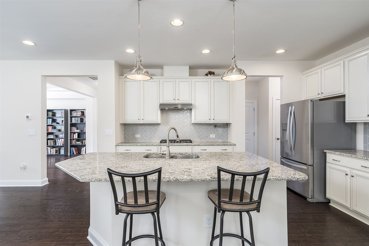 312 Morgan Ridge Road Holly Springs, NC 27540 - Photo 7 of 30 Gourmet Kitchen with Over-Sized Island and Timeless White Cabinetry