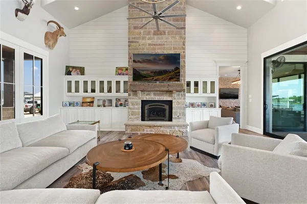 a bedroom with a bed a couch and chandelier