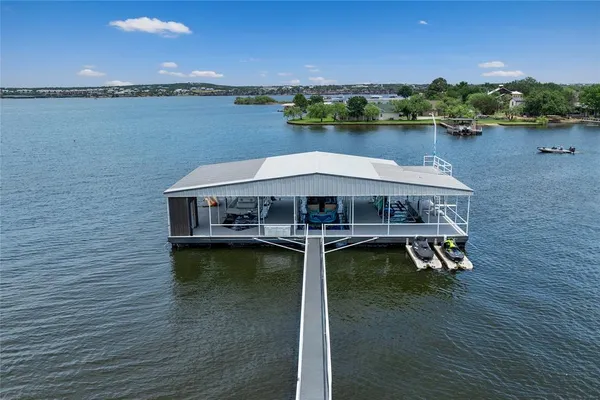 an aerial view of a house with a garden and lake view