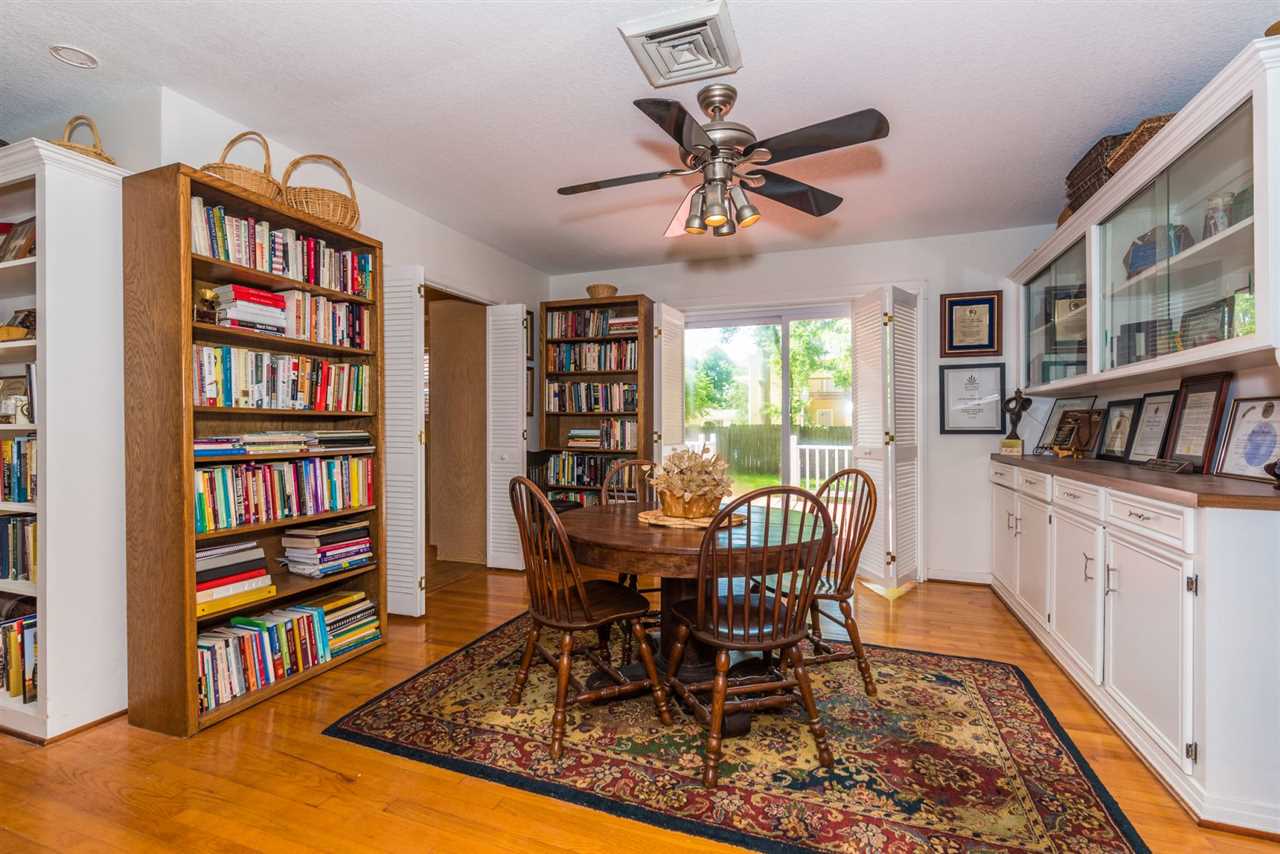 71 Valencia Street St. Augustine, FL 32084 - Photo 12 of 43 a dining room with furniture a book shelves and a rug