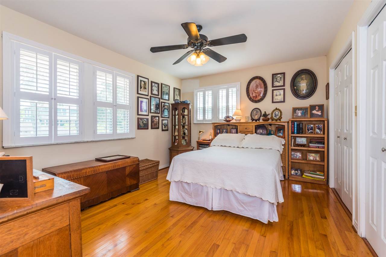 71 Valencia Street St. Augustine, FL 32084 - Photo 23 of 43 a spacious bedroom with a bed and a chandelier