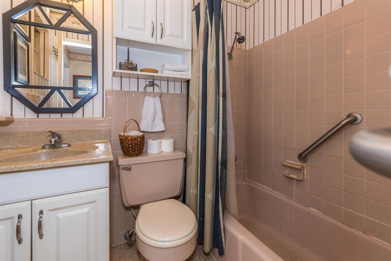 71 Valencia Street St. Augustine, FL 32084 - Photo 26 of 43 a bathroom with a granite countertop toilet a sink and a bathtub