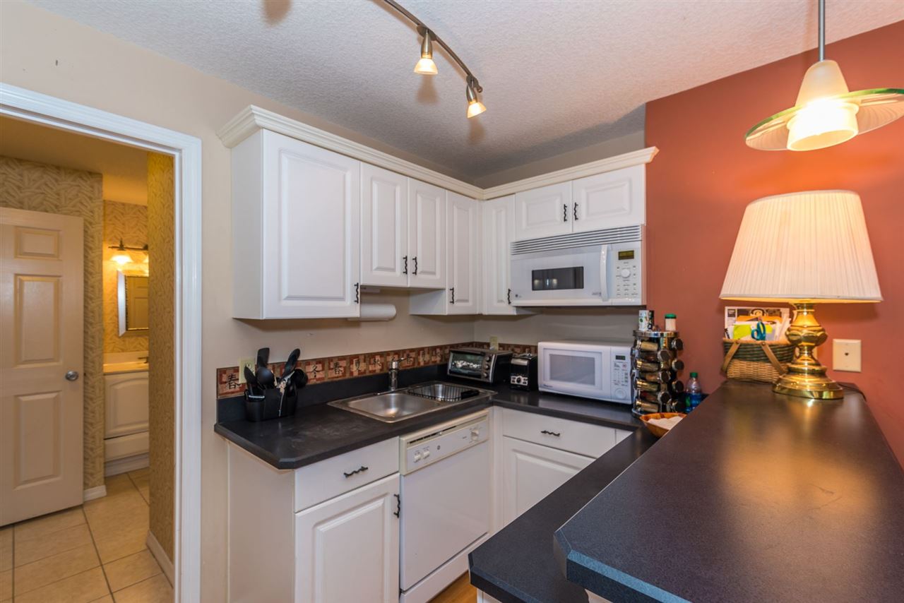 71 Valencia Street St. Augustine, FL 32084 - Photo 36 of 43 a kitchen with a sink stove and cabinets