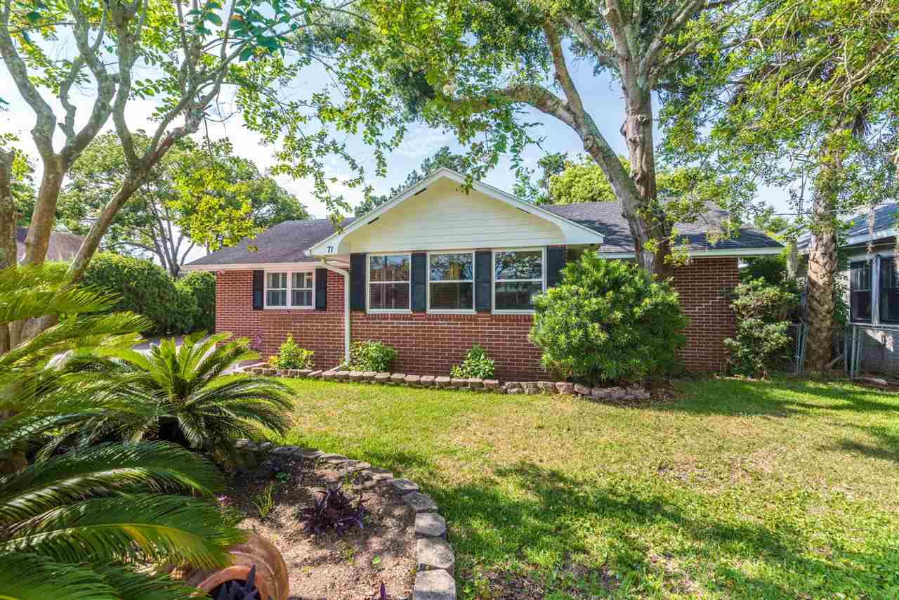 71 Valencia Street St. Augustine, FL 32084 - Photo 42 of 43 a front view of a house with a yard
