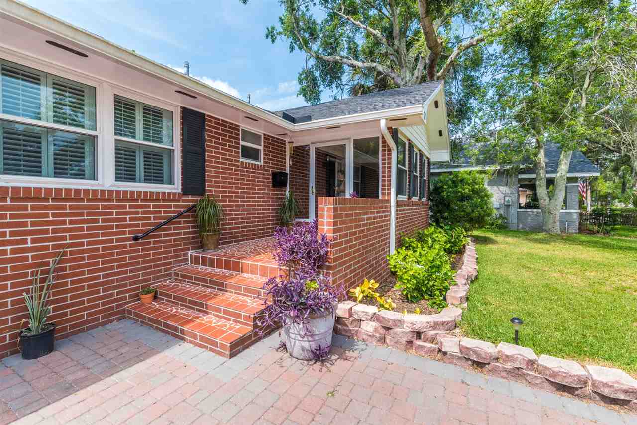 71 Valencia Street St. Augustine, FL 32084 - Photo 5 of 43 a front view of a house with garden