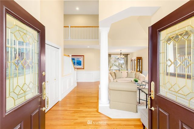 a bedroom with furniture and large windows