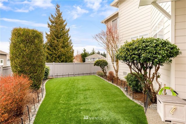 a view of a backyard with a table and chairs