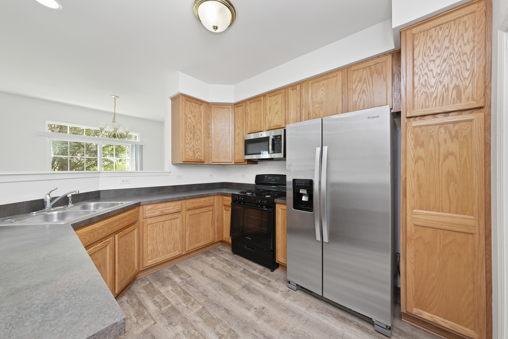276 South Oak Creek Lane Romeoville, IL 60446 - Photo 3 of 21 a kitchen with stainless steel appliances granite countertop a refrigerator a stove a sink and a refrigerator