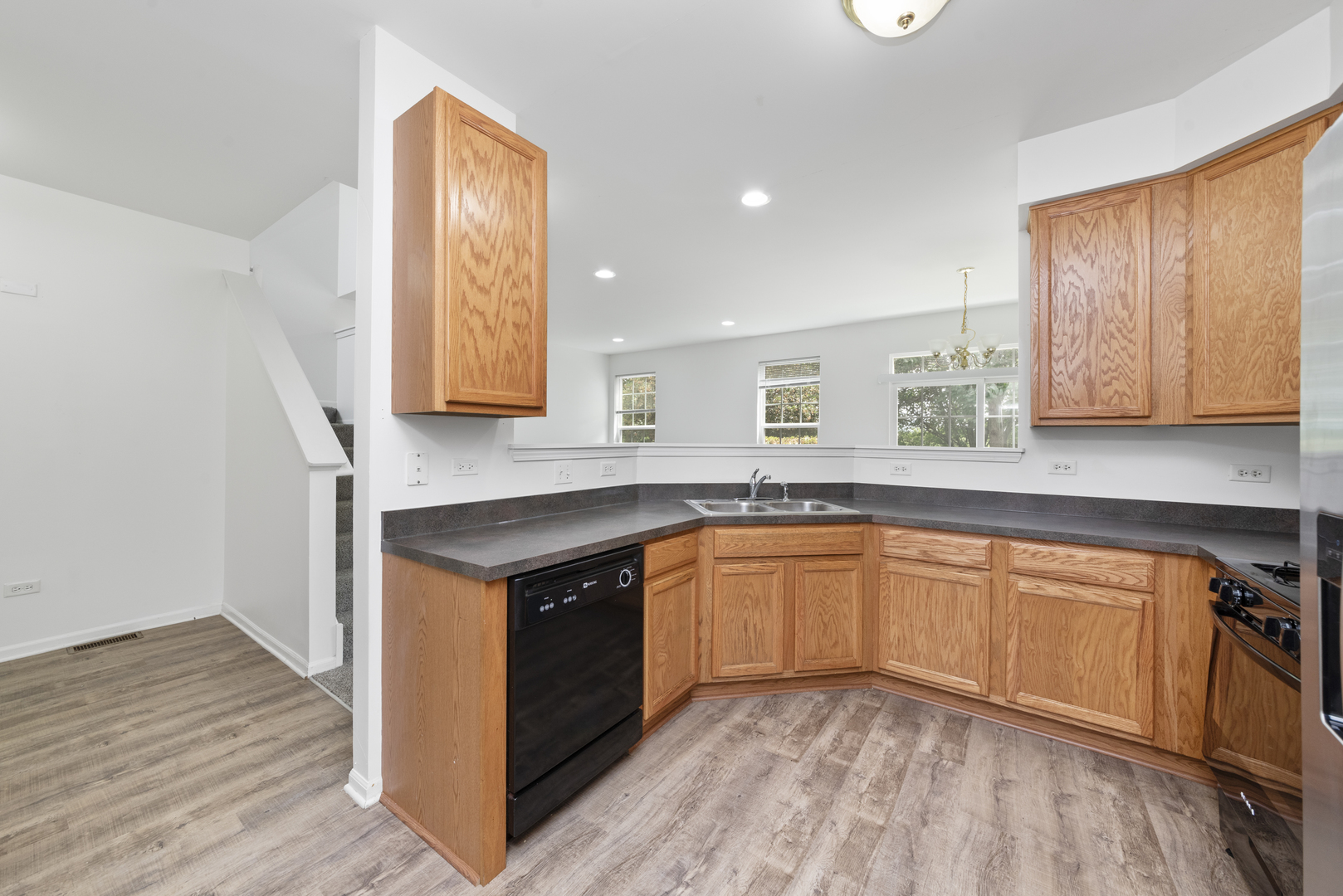 276 South Oak Creek Lane Romeoville, IL 60446 - Photo 4 of 21 a kitchen with stainless steel appliances granite countertop a stove a sink and a microwave