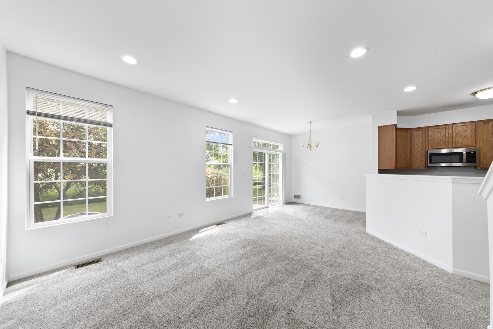 276 South Oak Creek Lane Romeoville, IL 60446 - Photo 6 of 21 a view of an empty room with a window and a kitchen