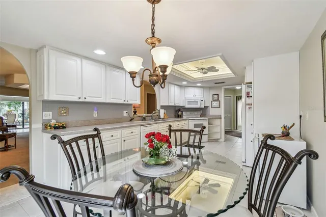 a dining room with furniture a livingroom and a chandelier