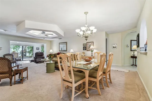 a view of a dining room with furniture and chandelier
