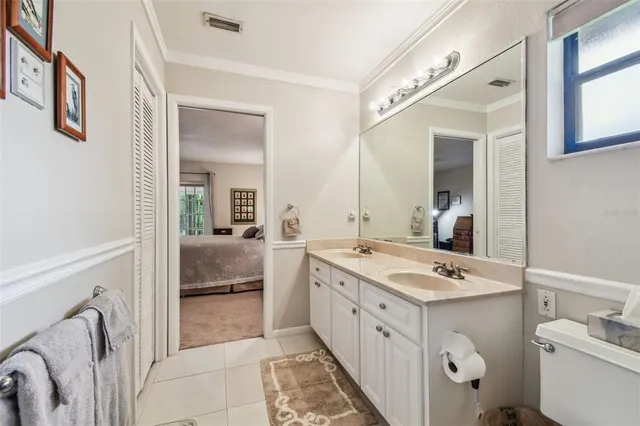 a bathroom with a double vanity sink toilet and shower