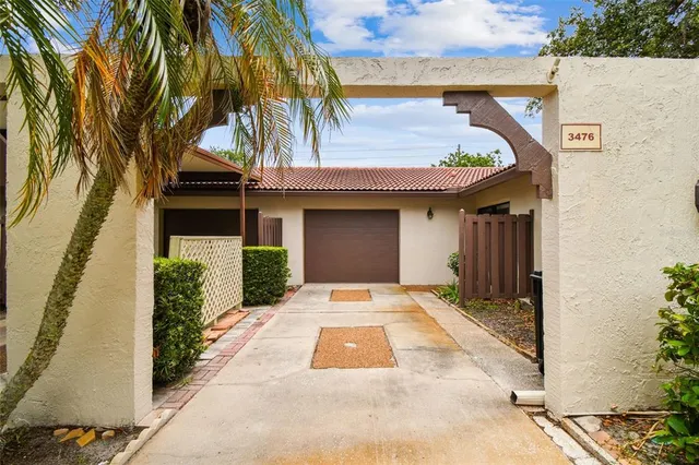 a view of a patio with table and chairs and potted plants