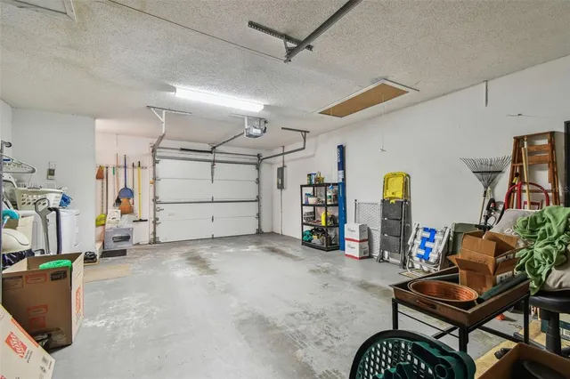 an aerial view of a house with a yard and large trees
