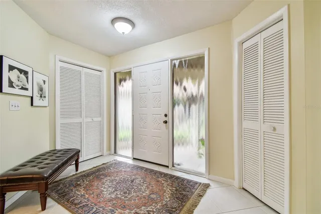 a kitchen with stainless steel appliances furniture cabinets and a rug