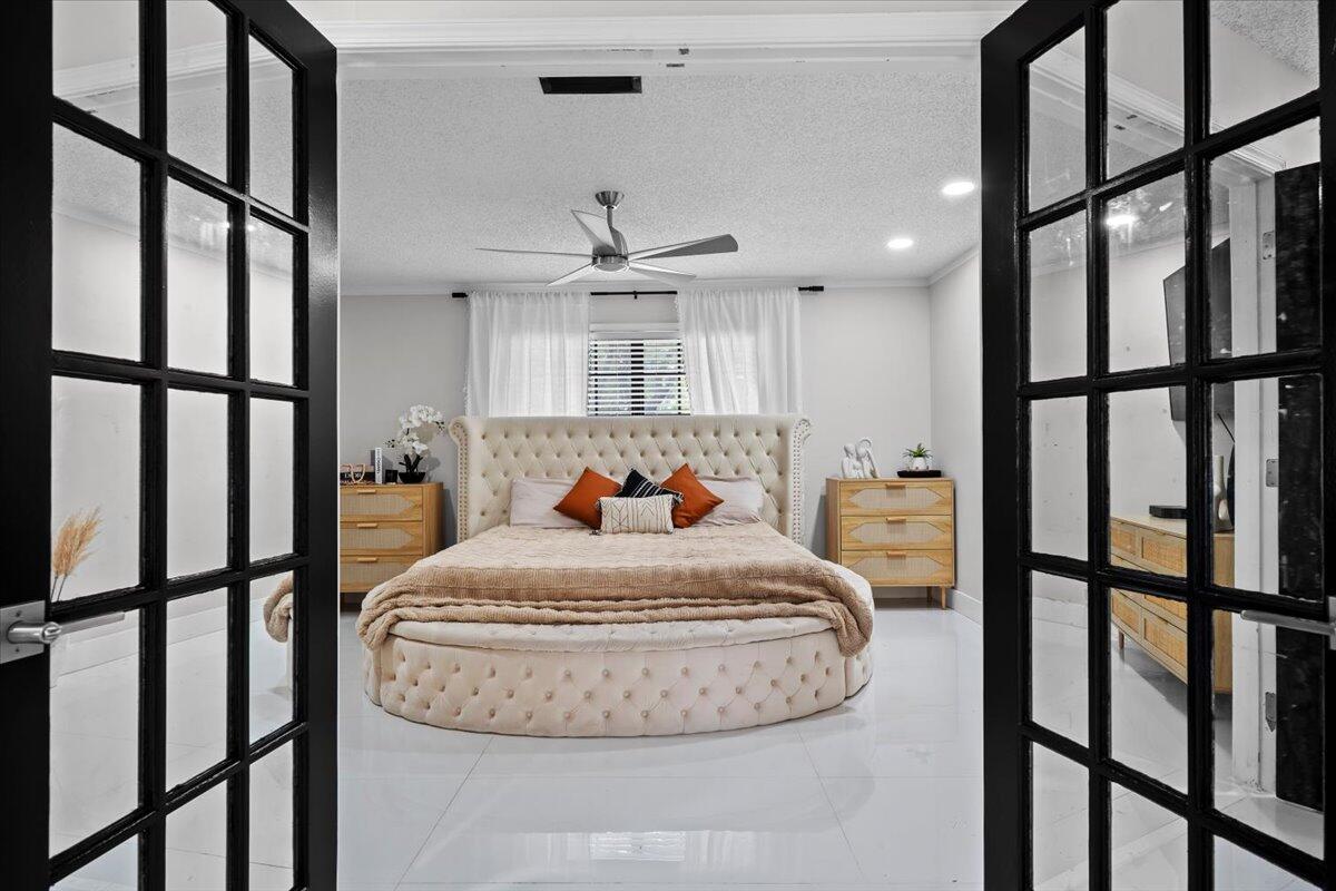 1779 Harborside Circle Wellington, FL 33414 - Photo 11 of 23 a view of a hallway with dining area and chandelier