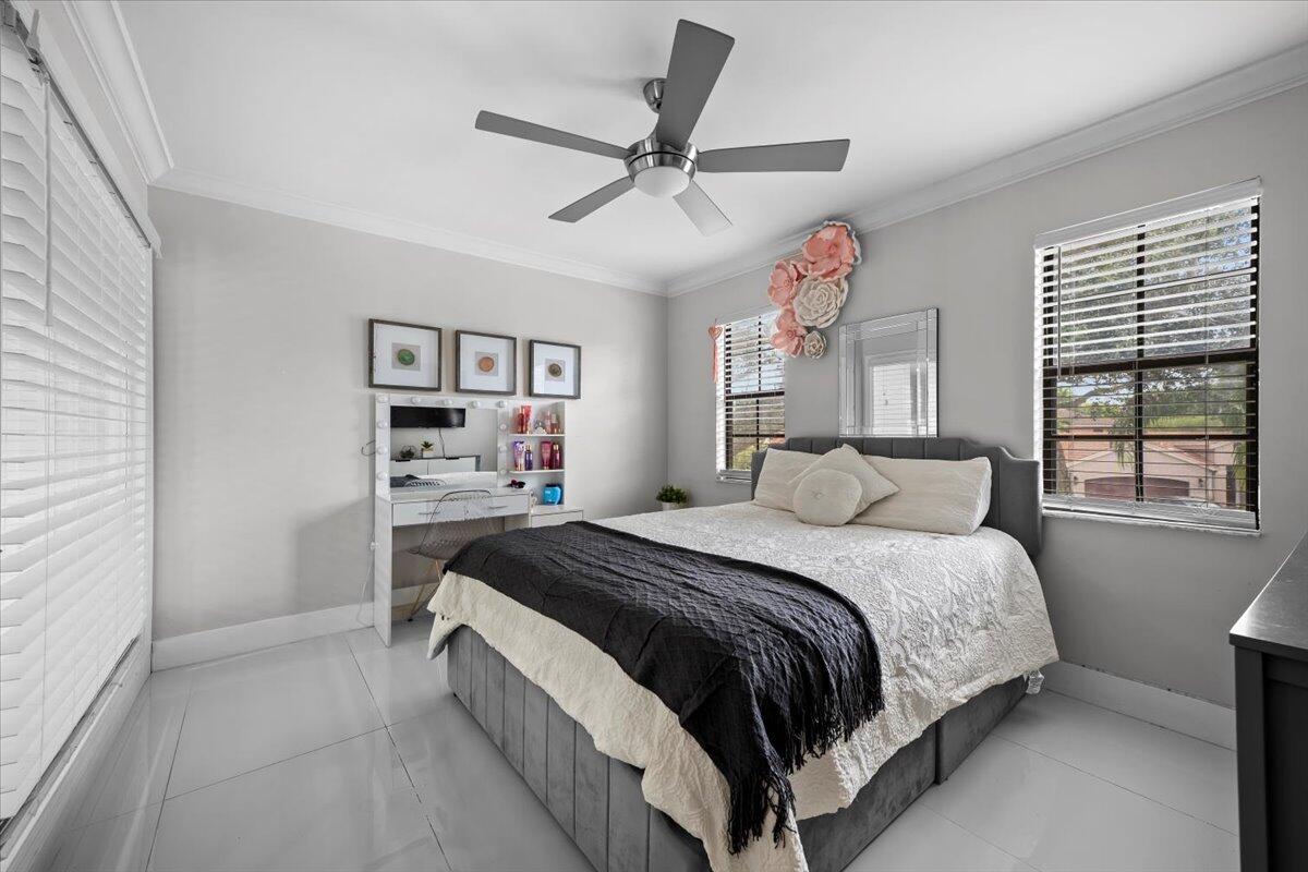 1779 Harborside Circle Wellington, FL 33414 - Photo 16 of 23 a spacious bedroom with a bed and a large window