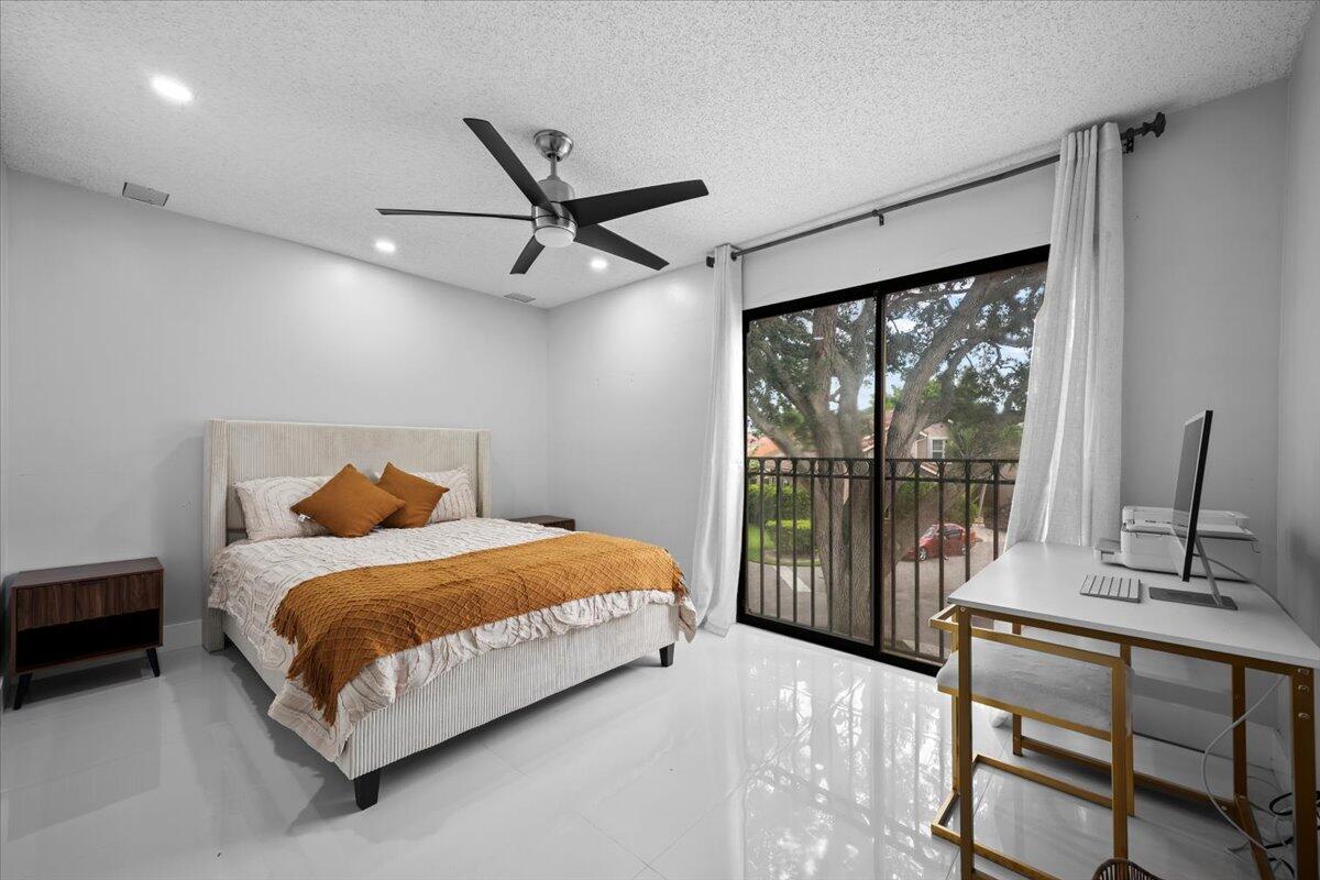 1779 Harborside Circle Wellington, FL 33414 - Photo 17 of 23 a bedroom with a large bed and a large window