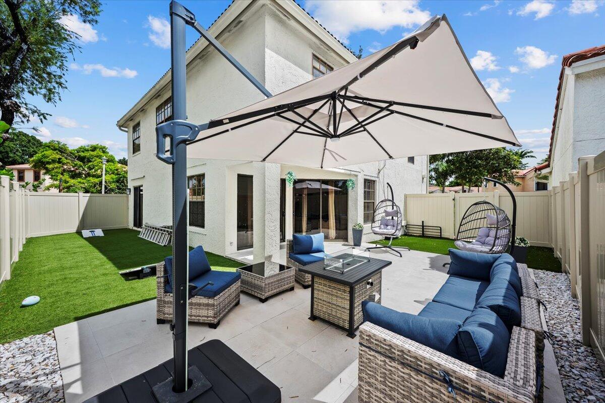 1779 Harborside Circle Wellington, FL 33414 - Photo 2 of 23 a view of a patio with couches table and chairs with potted plants