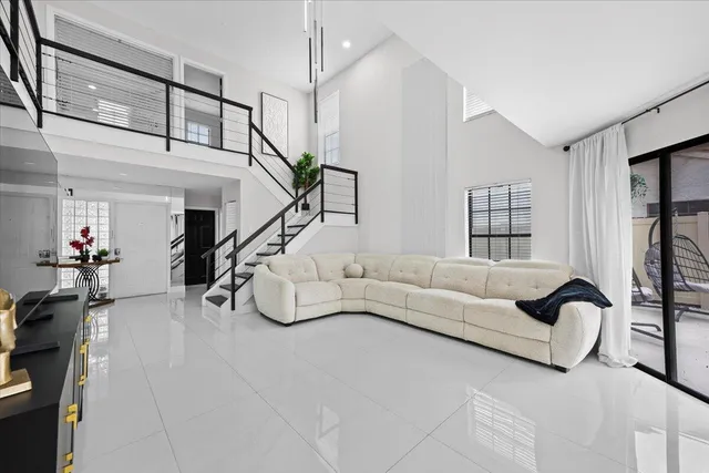 a living room with furniture and a chandelier