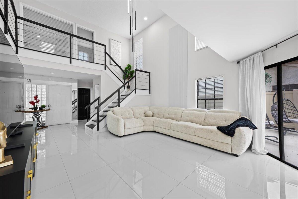 1779 Harborside Circle Wellington, FL 33414 - Photo 4 of 23 a living room with furniture and a chandelier