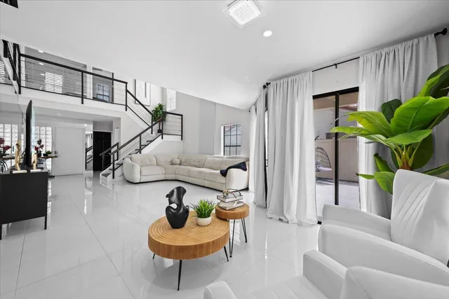a living room with furniture and a potted plant