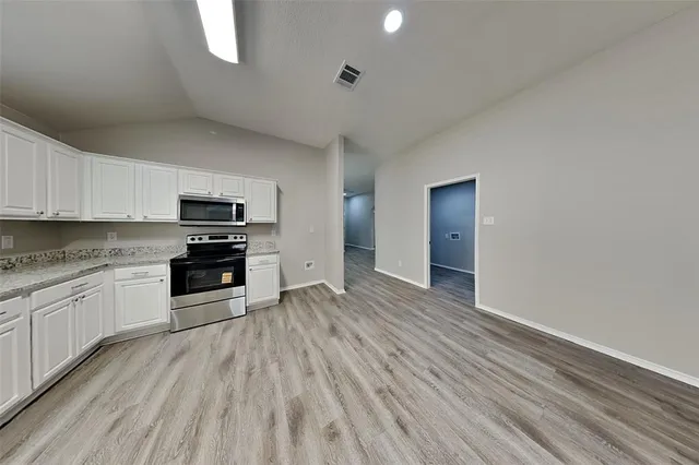 a kitchen with stainless steel appliances a stove top oven and sink