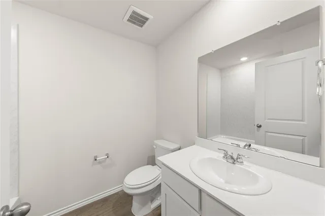 a bathroom with a sink toilet and a mirror