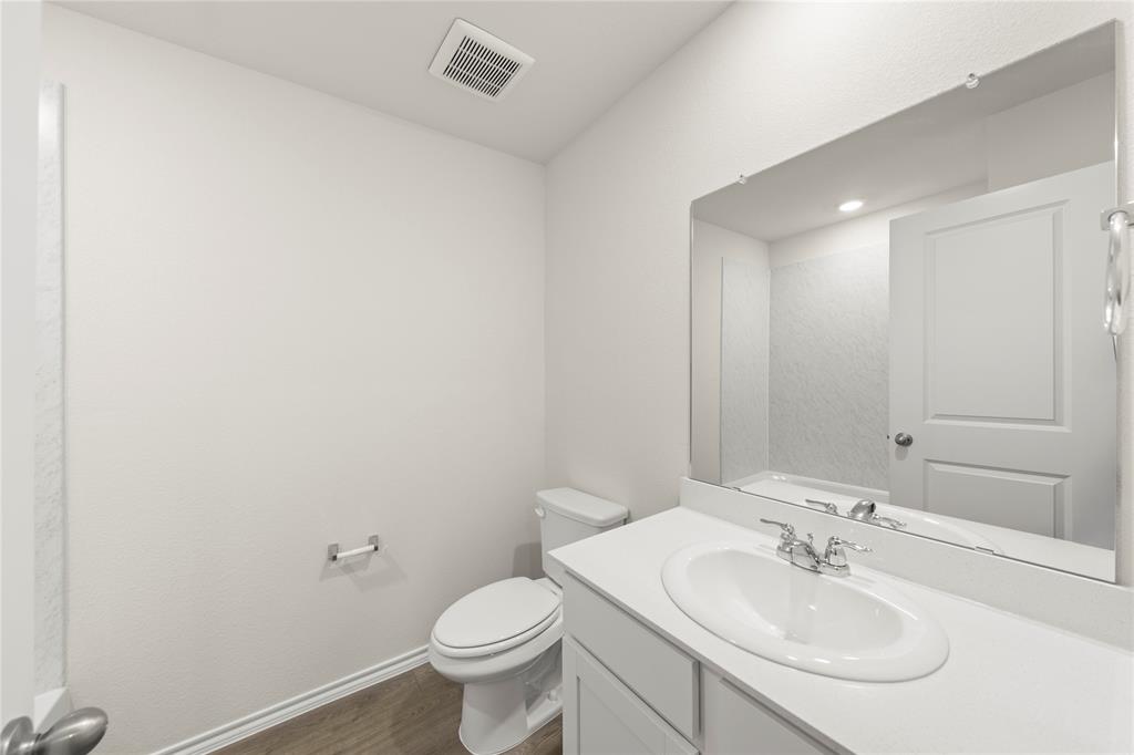 3420 Rendezvous Way Sherman, TX 75090 - Photo 5 of 13 a bathroom with a sink toilet and a mirror