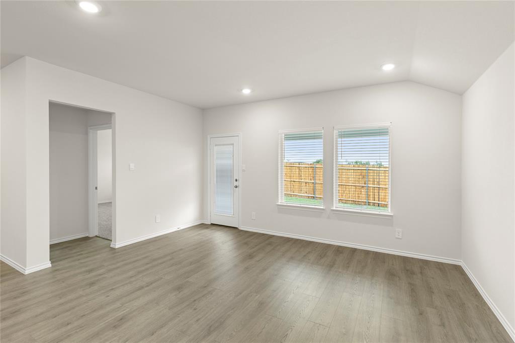 3420 Rendezvous Way Sherman, TX 75090 - Photo 7 of 13 a view of an empty room with wooden floor and a window