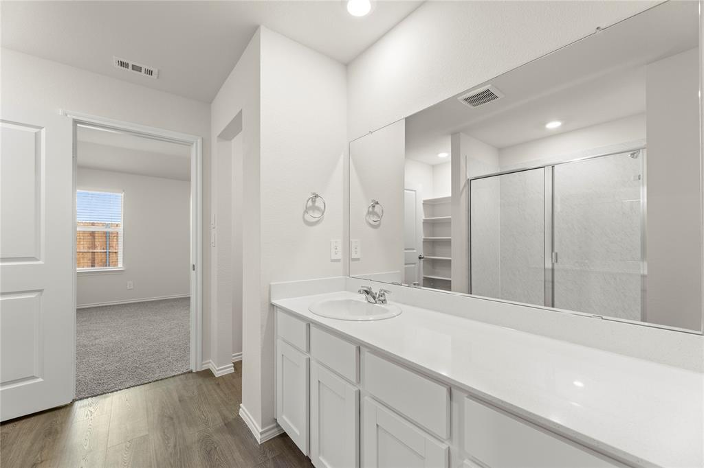 3420 Rendezvous Way Sherman, TX 75090 - Photo 10 of 13 a bathroom with a shower sink and mirror